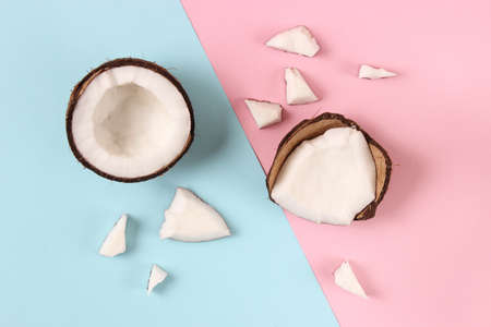 broken coconut on a colored background top view.の写真素材