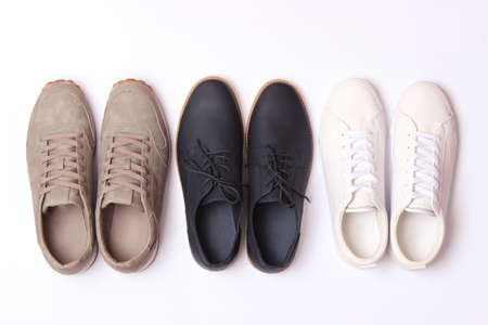 mens office shoes and sneakers on a colored background top view. mens shoes,の写真素材
