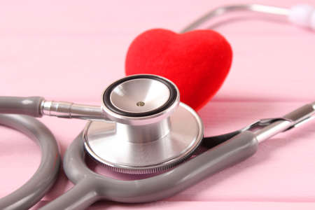 Stethoscope and heart on wooden color background. Health, medicineの写真素材