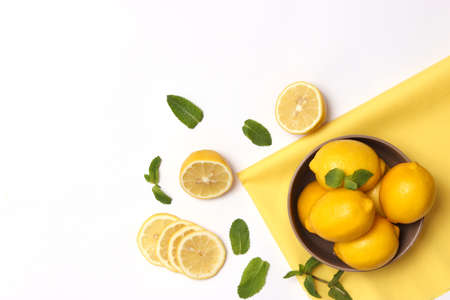 lemons and green leaves on a colored background.の写真素材