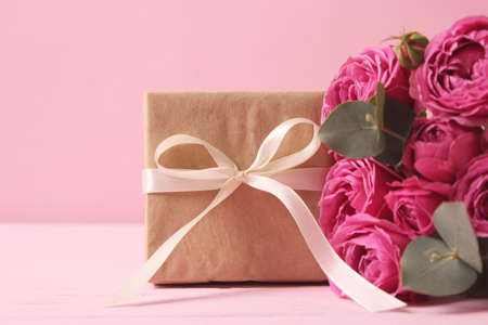 gift and flowers on a colored background. Holiday, give a gift, congratulations.の写真素材