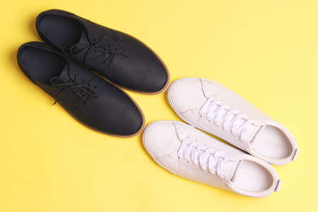 mens office shoes and sneakers on a colored background top view. mens shoes,の写真素材