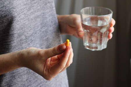 Medical pills in female hands. Take pills. Vitamins, food additives.