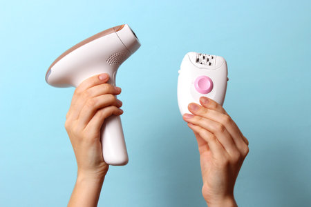 Home modern photoepilator and mechanical epilator in female hands.の写真素材