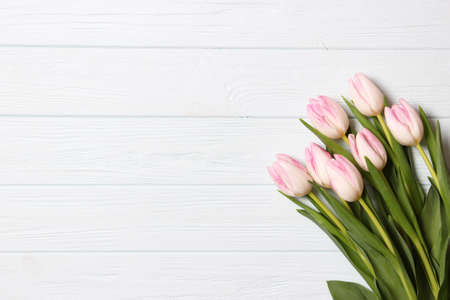 A bouquet of tulips on a wooden background top view. Spring background.の写真素材