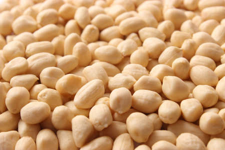 raw peeled peanuts on a light background