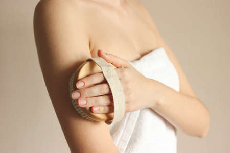 Brushes for massage in female hands. Prevention of cellulite, skin care.の写真素材