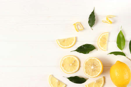 lemons and green leaves on a colored background.の写真素材