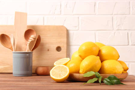 lemons and green leaves on a colored background.の写真素材