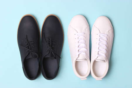 mens office shoes and sneakers on a colored background top view. mens shoes,