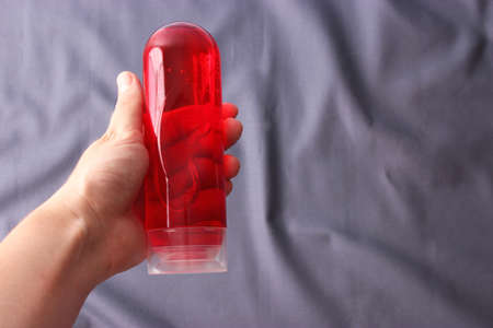 An intimate lubricant for comfortable sex close-up on a colored background.の写真素材
