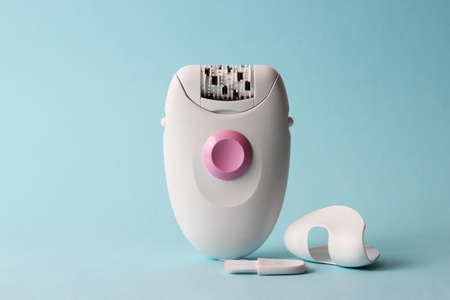 Modern mechanical epilator on a colored background close-up.の写真素材