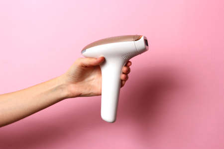 Modern home photoepilator in female hands. Remove unwanted hair.の写真素材