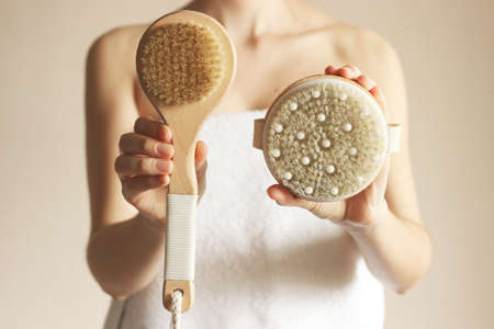 Brushes for massage in female hands. Prevention of cellulite, skin care.