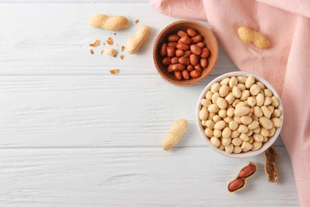 raw peeled peanuts on a light background
