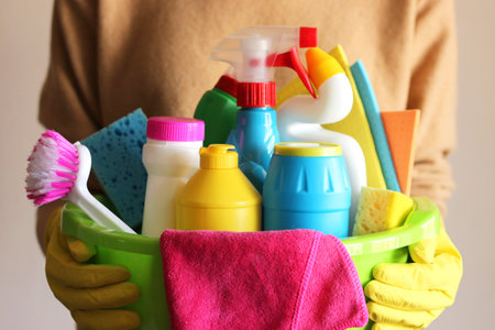 Housewife holds a basket with cleaning and disinfection productsの写真素材