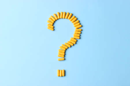 Pills on a colored background top view close-up. Medicines, vitaminsの写真素材