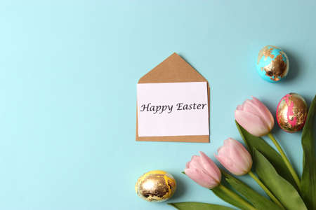 Easter composition of painted eggs and feathers on a colored background.の写真素材