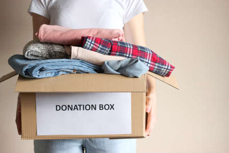 girl holding a box with donationsの写真素材