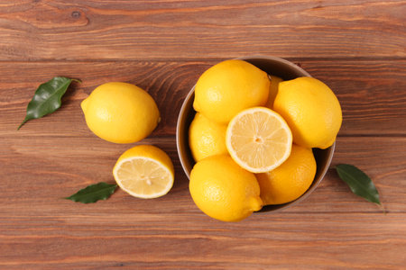 lemons and green leaves on a colored background.の写真素材