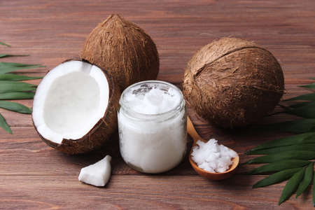 coconut oil and coconuts, palm branches close up