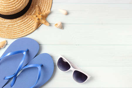travel accessories and tropical leaves on a colored background top view.