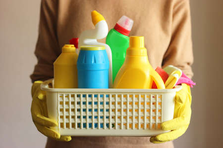 Housewife holds a basket with cleaning and disinfection productsの写真素材