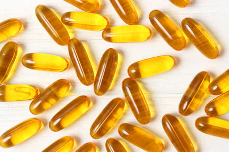 Omega-3 capsules on a colored background. Fish oil, healthy supplementsの写真素材