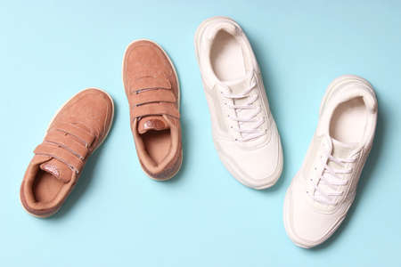 shoes for children and womens sneakers on a colored background top view.の写真素材