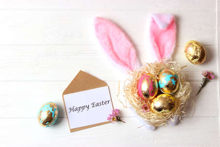 Easter composition of painted eggs and feathers on a colored background.の写真素材