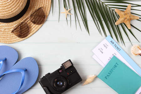 travel accessories and tropical leaves on a colored background top view.の写真素材