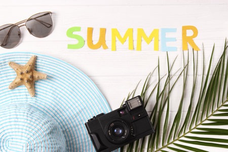 travel accessories and tropical leaves on a colored background top view.の写真素材
