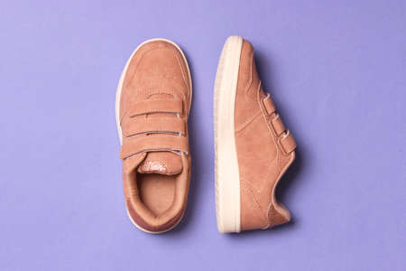 Childrens shoes on a colored background top view. Childrens footwear.の写真素材