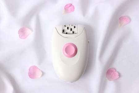 Modern mechanical epilator on a colored background close-up.の写真素材