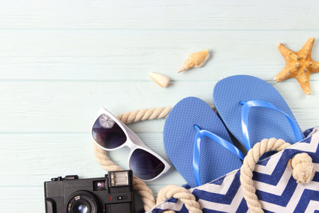 travel accessories and tropical leaves on a colored background top view.の写真素材