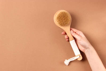 brush for dry massage on a colored background top view.