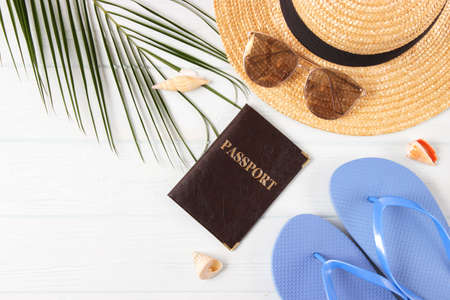 travel accessories and tropical leaves on a colored background top view.の写真素材