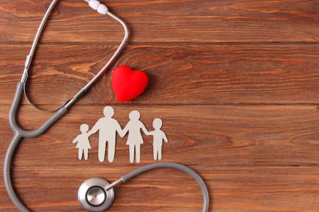 stethoscope and heart on a colored background top view. Family medicineの写真素材