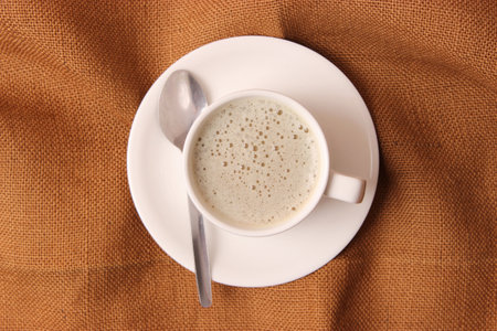 Cup of coffee with froth close up with place for text