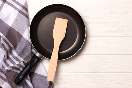 frying pan and on the wooden table top view. Cooking.
