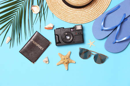 travel accessories and tropical leaves on a colored background top view.の写真素材