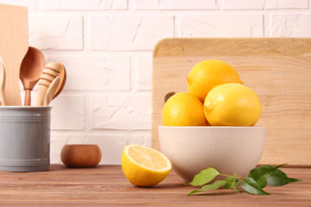 lemons and green leaves on a colored background.