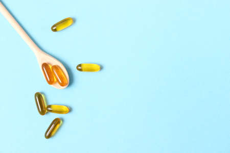 Omega-3 capsules on a colored background. Fish oil, healthy supplementsの写真素材