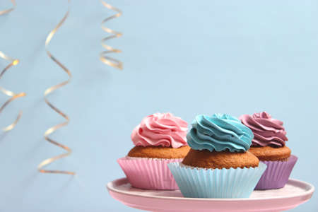 Delicious cupcake with a candle on a colored background with space for text.の写真素材