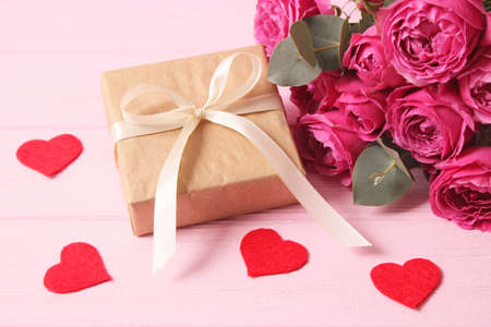 gift and flowers on a colored background. Holiday, give a gift, congratulations.の写真素材