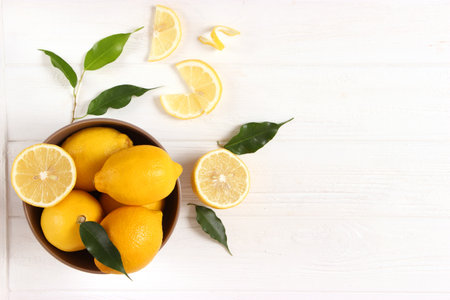 lemons and green leaves on a colored background.の写真素材