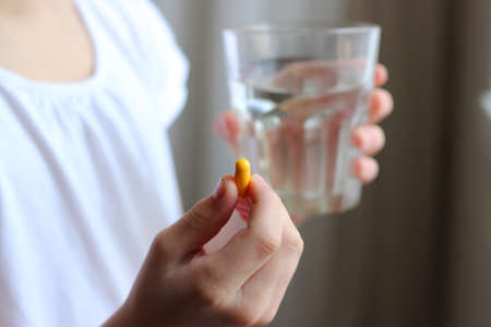 Medical pills in the hands of a child close-up.の写真素材