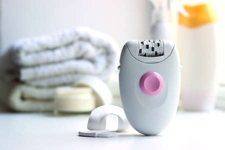 Modern mechanical epilator on a colored background close-up.の写真素材
