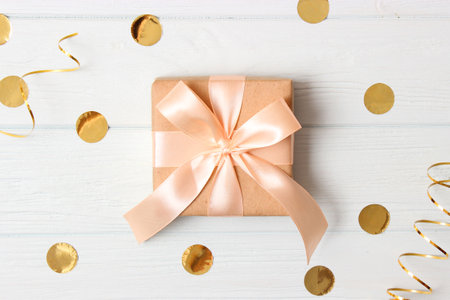 gift and sparkles of confetti on a colored background top view. minimalismの写真素材