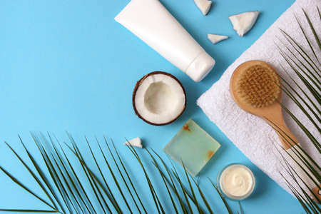 Cosmetic jars and coconut on the table close-up and place for text.の写真素材